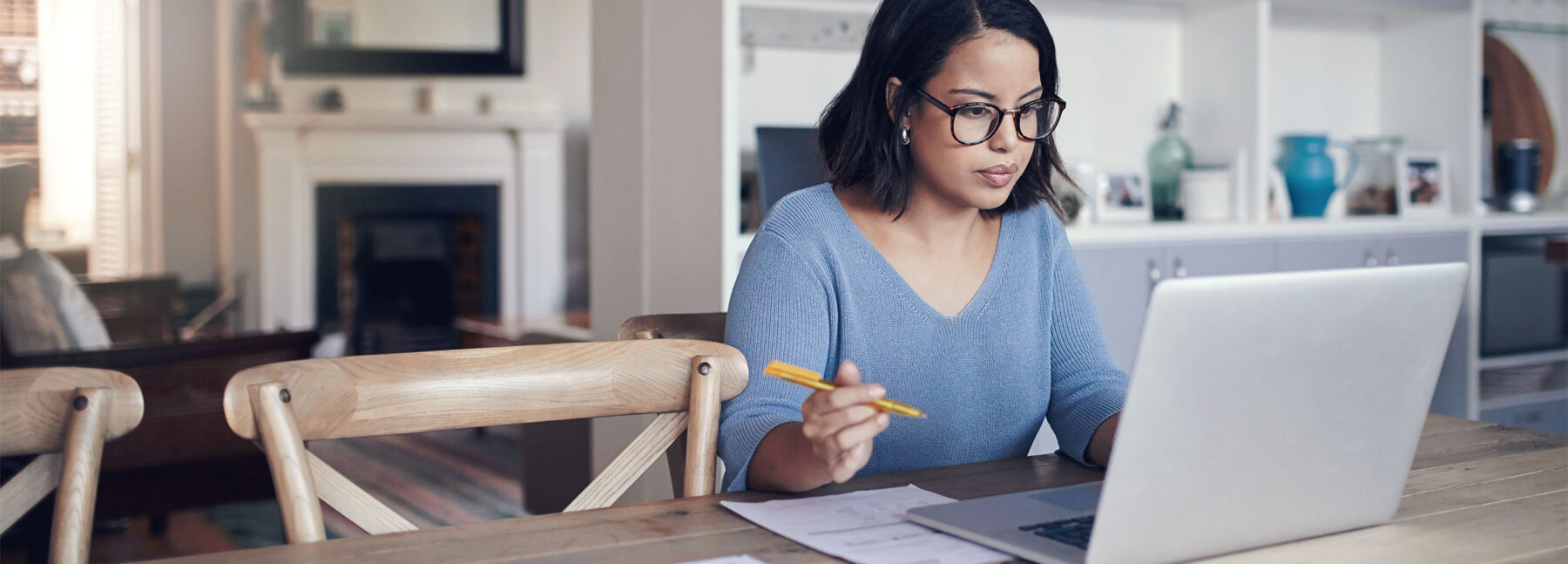 women sat at table with laptop