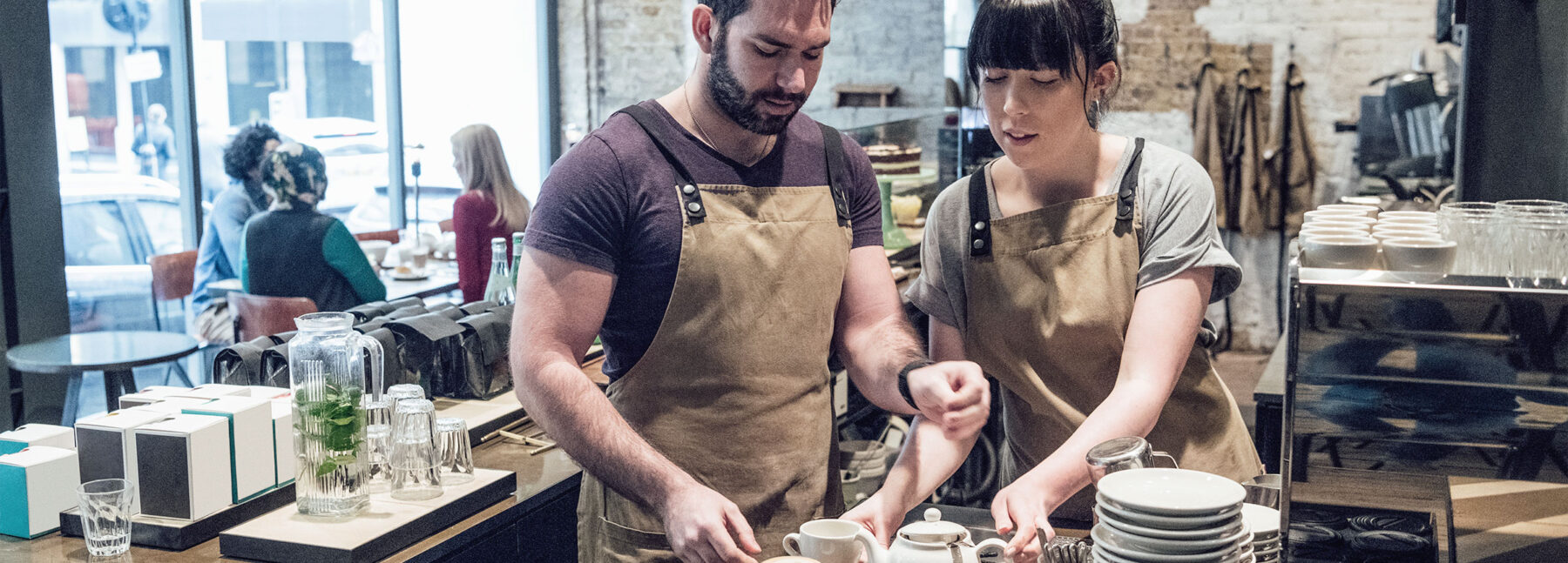 male and female staff serving in cafe