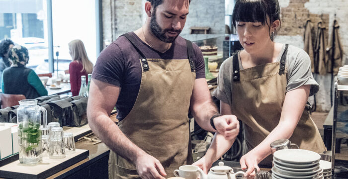 male and female staff serving in cafe