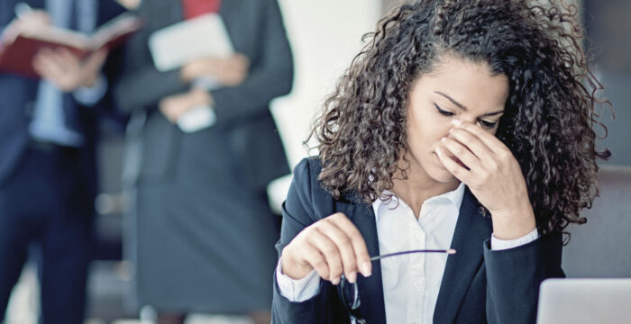 women in office environment, looking stressed