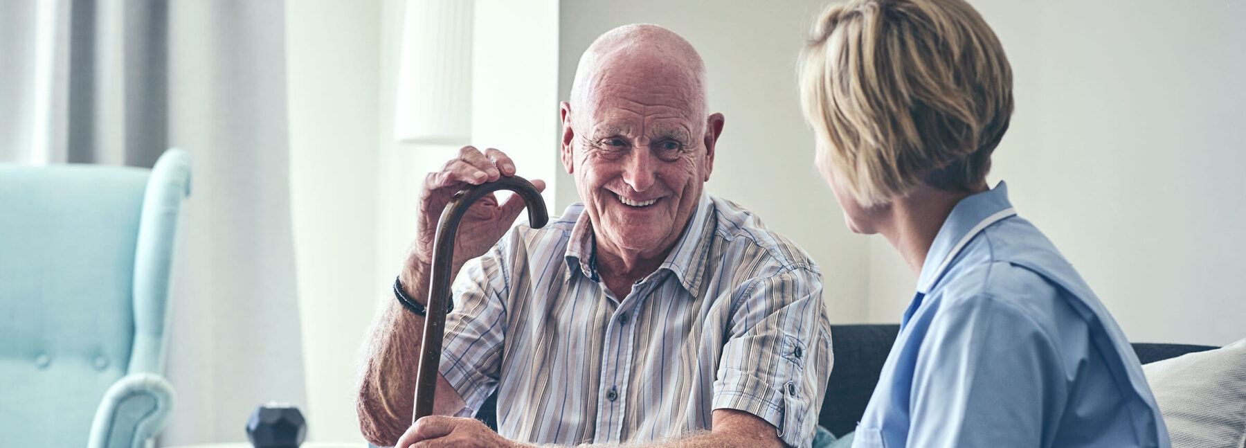 Elderly man in care home with nurse