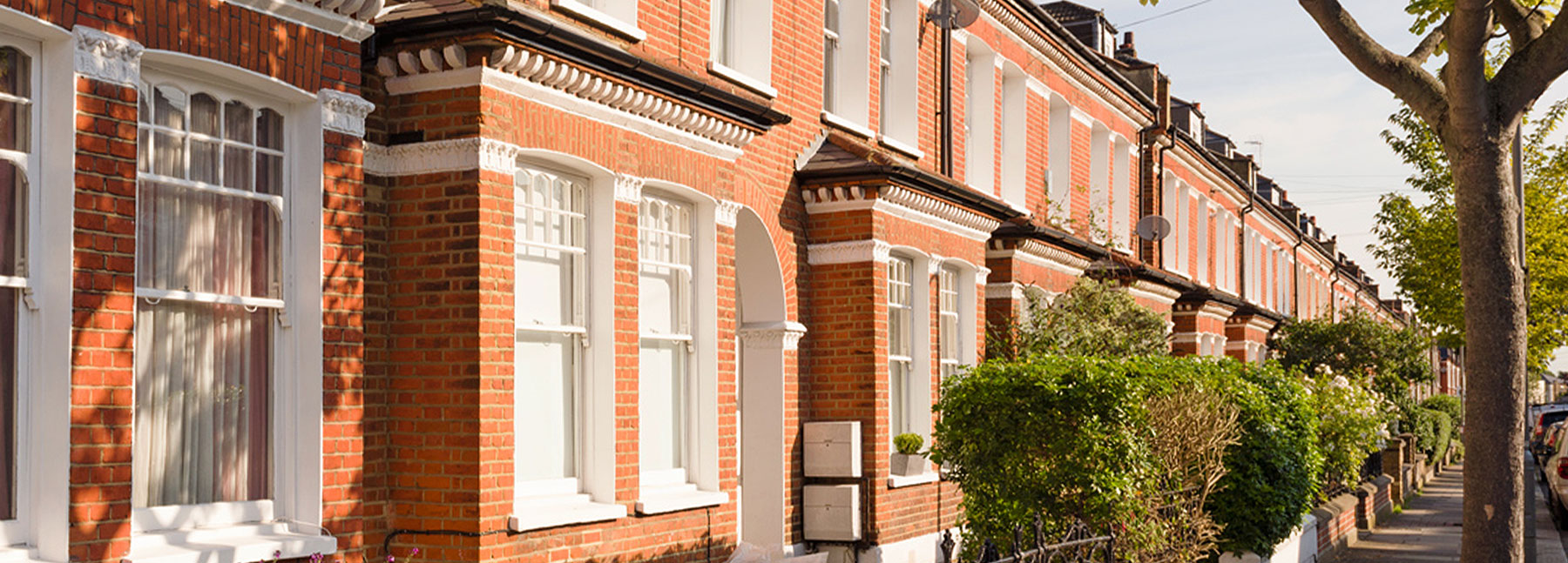 close up of red brick terraced houses