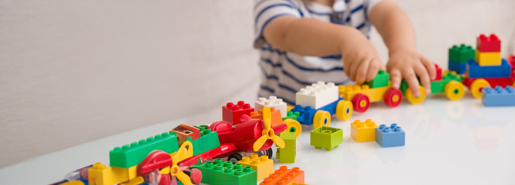child playing with lego train