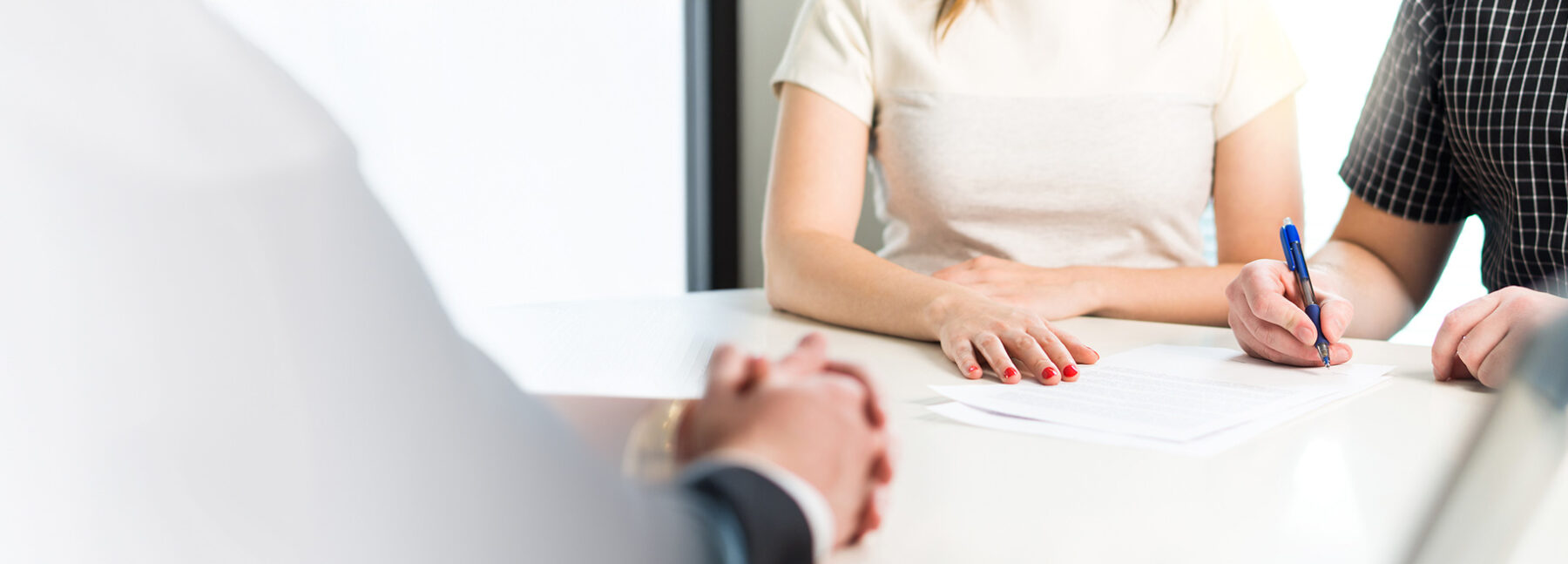 couple signing documents with solicitor present