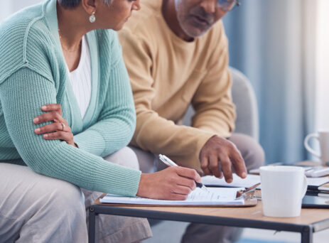 senior couple looking at will documents