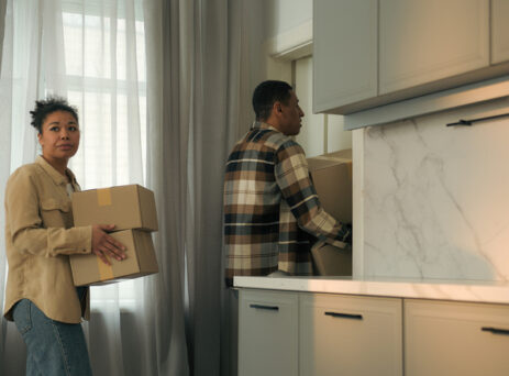Couple taking boxes out of home after being evicted