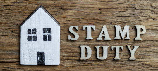 stamp duty writing on wooden background